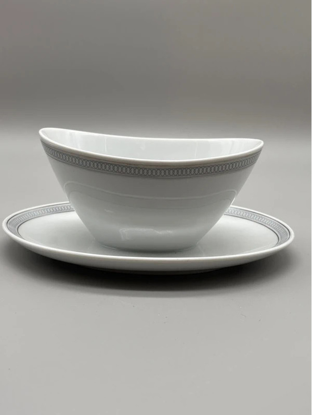 Ceramic gravy boat with attached under plate